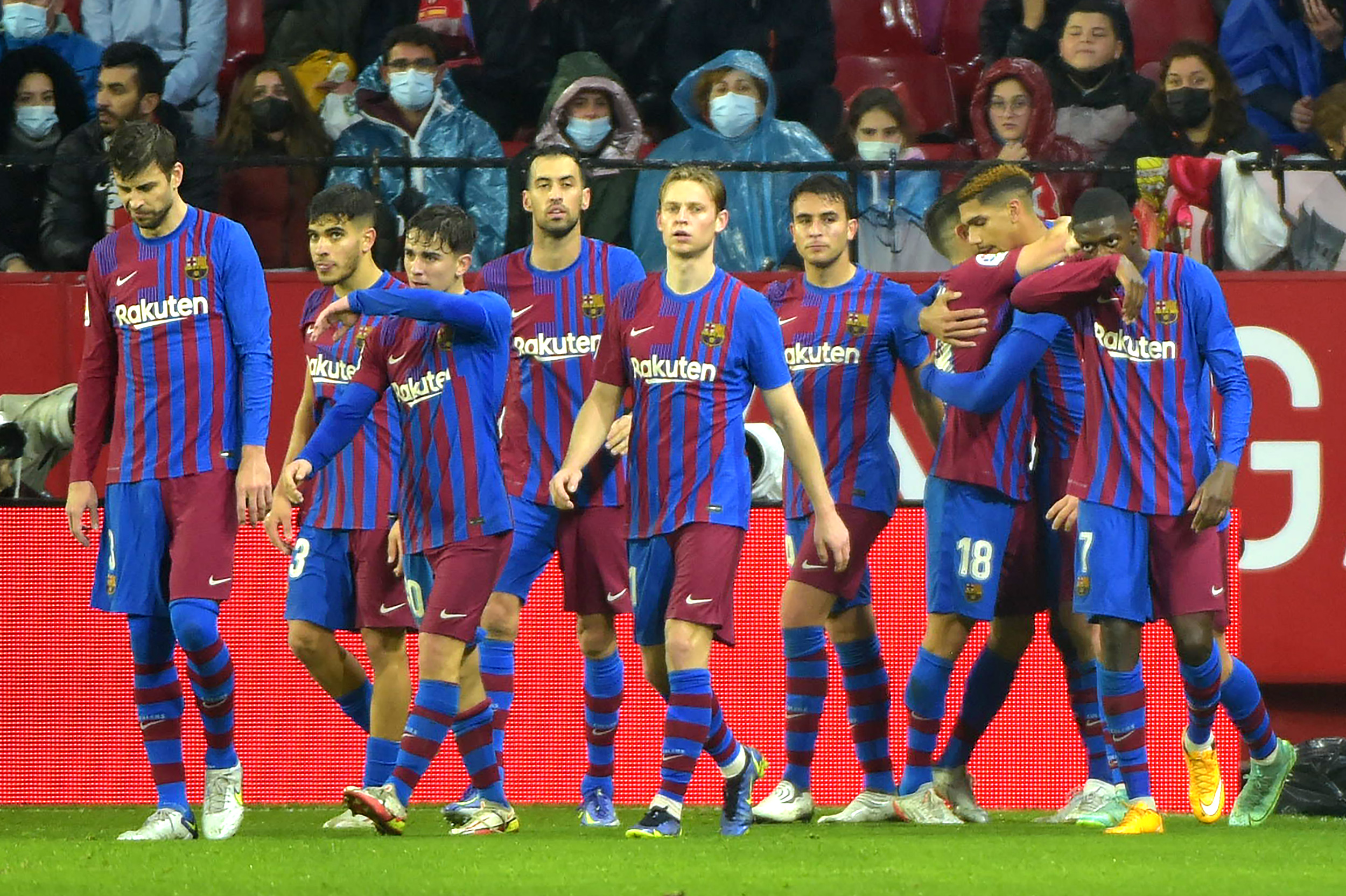 Barcelona's Uruguayan defender Ronald Araujo (2R) celebrates with teammates after scoring his team's first goal during the Spanish league football match between Sevilla FC and FC Barcelona at the Ramon Sanchez Pizjuan stadium in Seville on December 21, 2021. (Photo by CRISTINA QUICLER / AFP) (Photo by CRISTINA QUICLER/AFP via Getty Images)